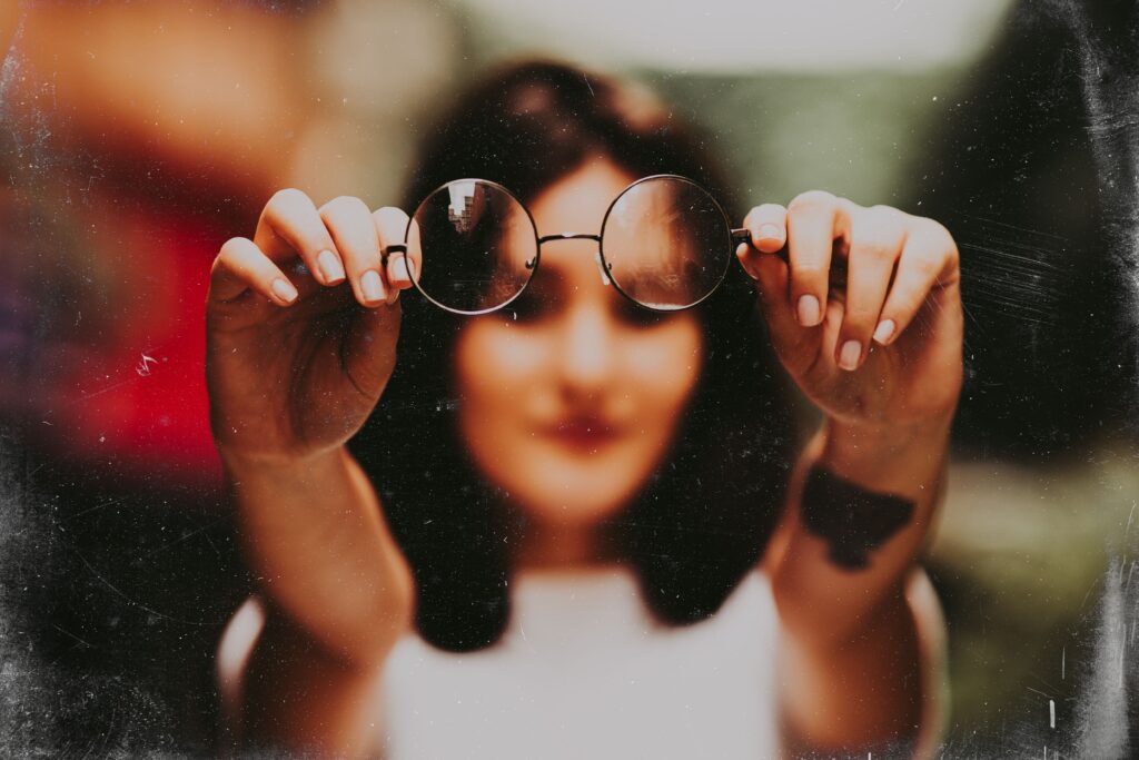 woman holding up glasses
