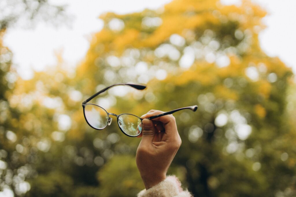 holding up glasses
